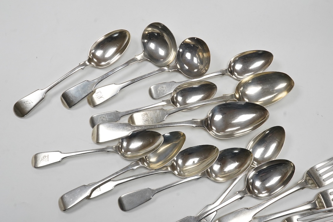 A matched part canteen of 19th century silver fiddle pattern flatware, various dates and makers, including a set of four George III table forks, Eley & Fearn, London, 1807, 28oz, and one plated table spoon.